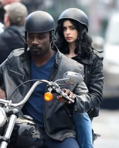 Mike Colter and Krysten Ritter as Luke Cage and Jessica Jones respectively