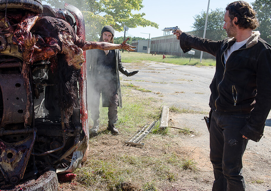 Rick holding a gun on Jesus