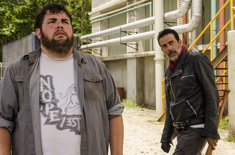 Negan and a Savior looking at an unseen Carl on The Walking Dead