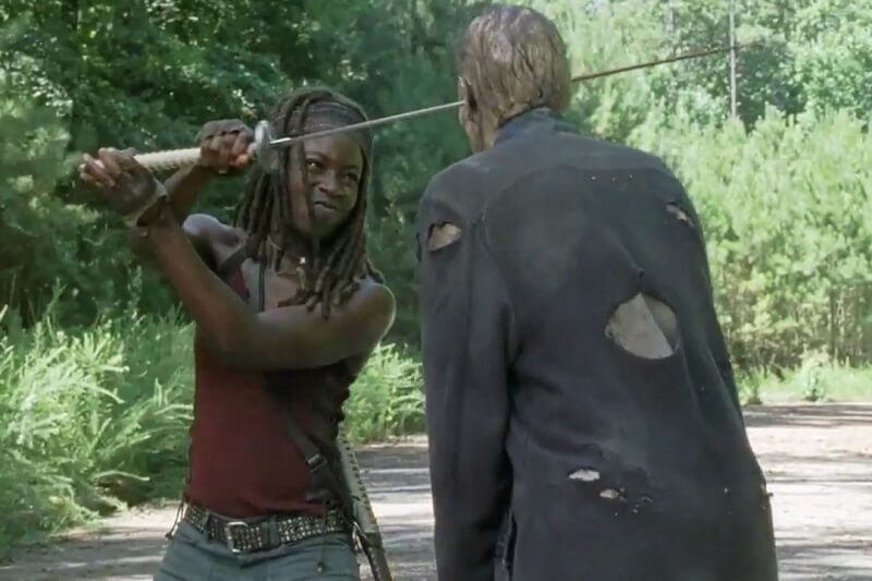 Mihconne stabbing a walker in the head with her sword