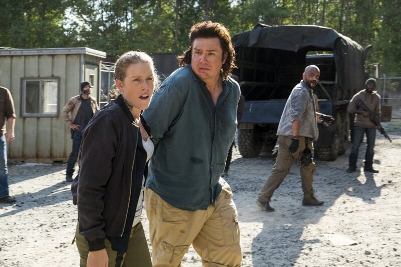 A captive Eugene being lead into the Sanctuary by Savior Laura