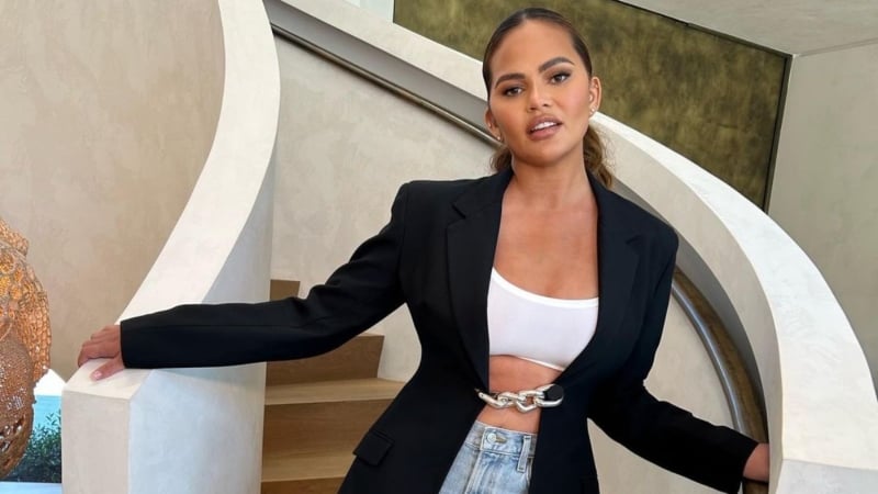 Chrissy Teigen rocks crop tp and jacket