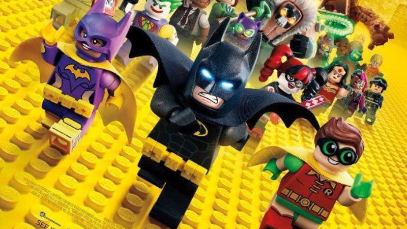 Batman and his allies run toward the camera on the poster for The Lego Batman Movie.