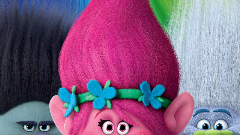 A close-up of three of the trolls from the Trolls film, based on the brand of retro toys.