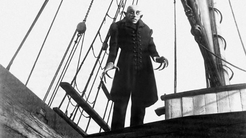 Nosferatu stands on the deck of a ship in the classic vampire film Nosferatu (1922)
