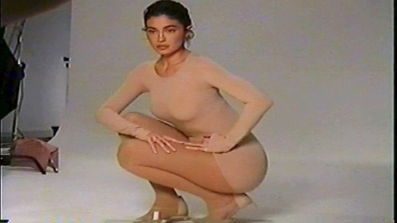 Kylie poses in front of a white background for product launch