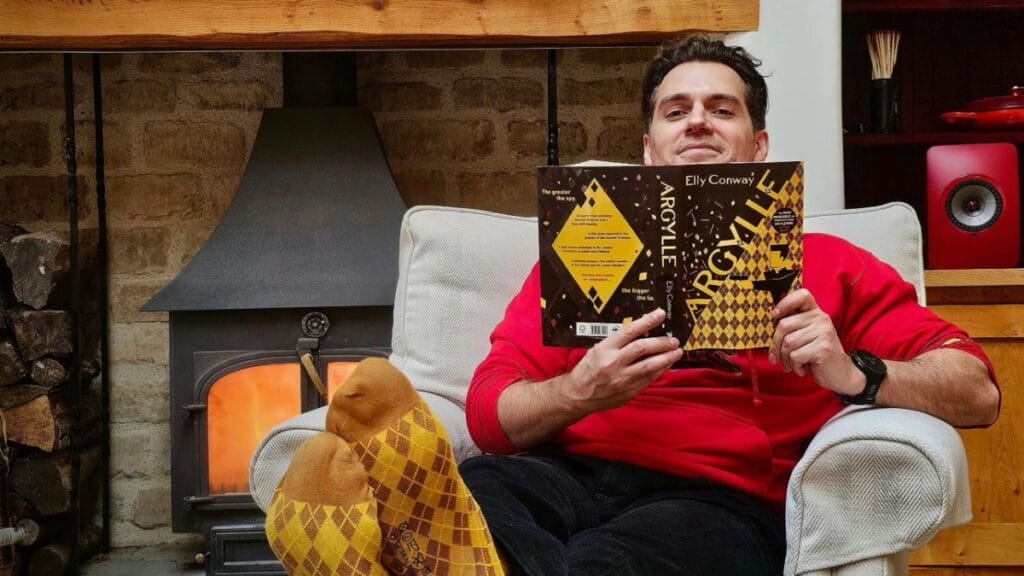Henry Cavill reading Argylle with his feet up