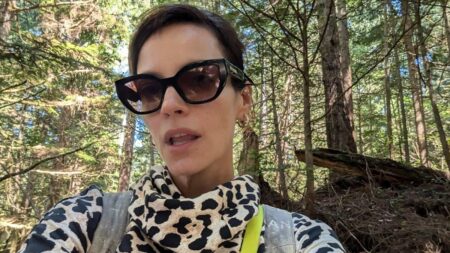 Lily Allen in a dog print turtleneck top and glasses