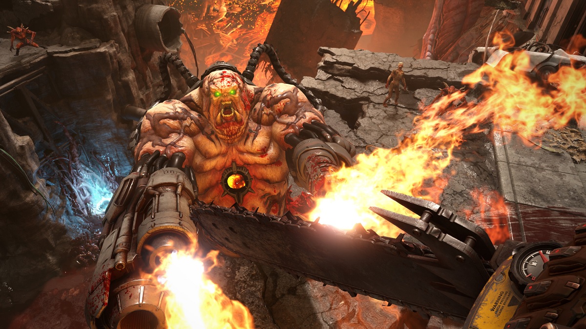 doom guy slaying a mancubus with chainsaw in eternal doom