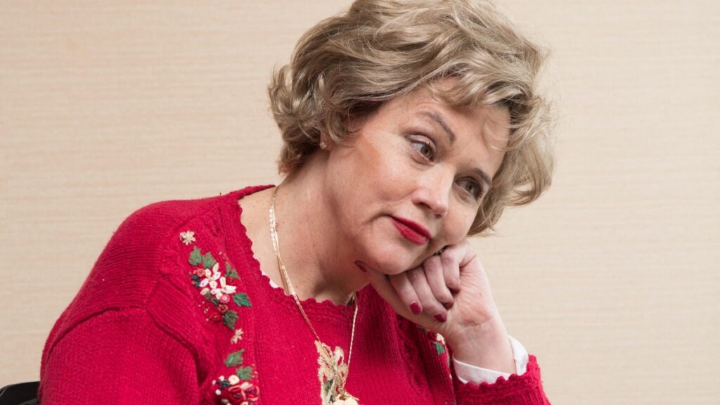 Meghan Markle's half-sister Samantha Markle in a red sweater.