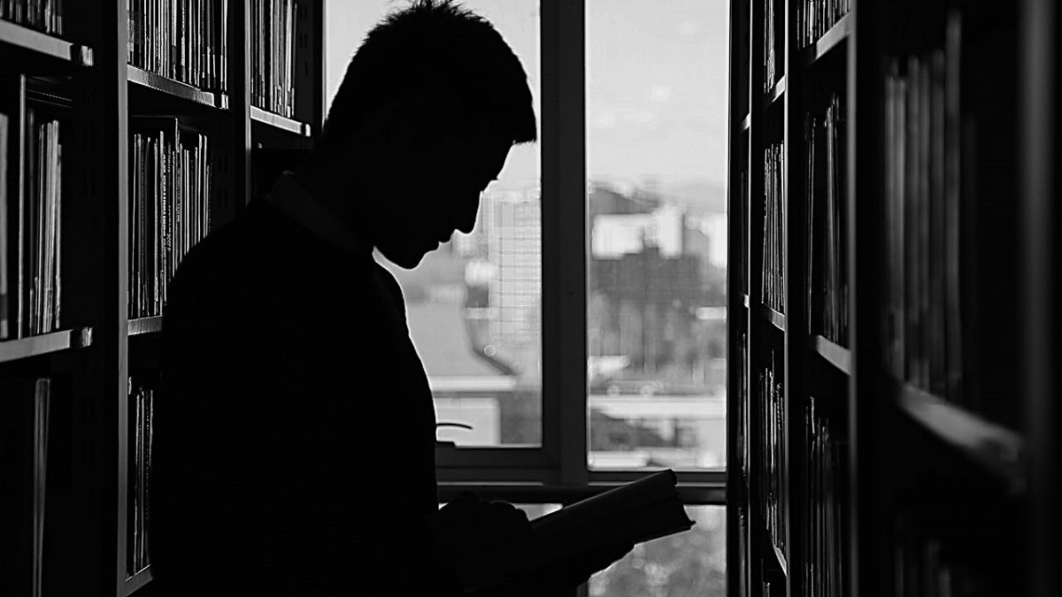 a person reading a book in a library