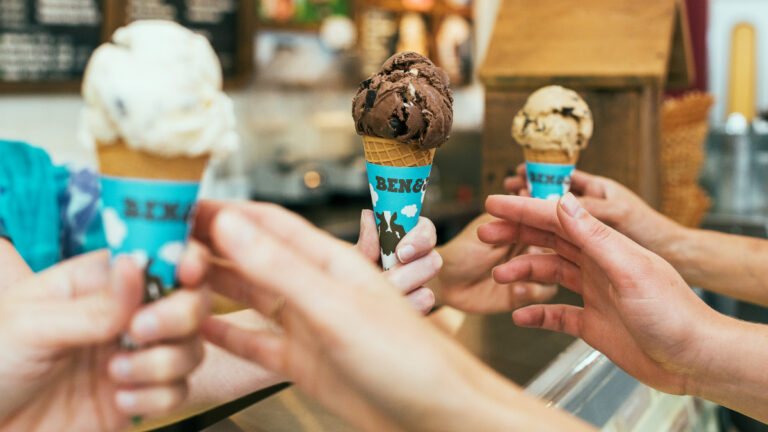The Women’s March of 2017 Is Back in Washington, D.C. As the People’s March of 2025, and Ben & Jerry’s Wants You To Eat It Up Three hands reach for ice cream cones during Ben & Jerry's Free Ice Cream Day