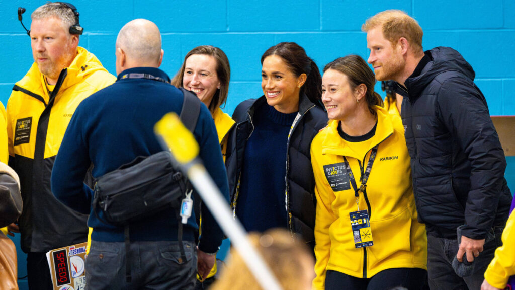 Prince Harry and Meghan Markle pose with team members at the Invictus Games Vancouver 2025.