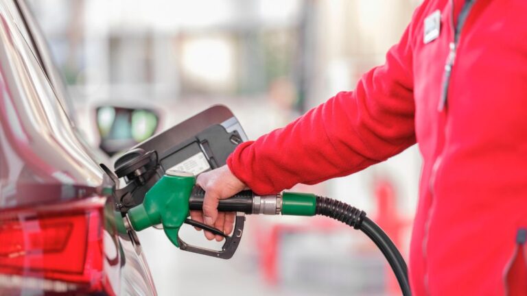 Man pumping gas at gas station
