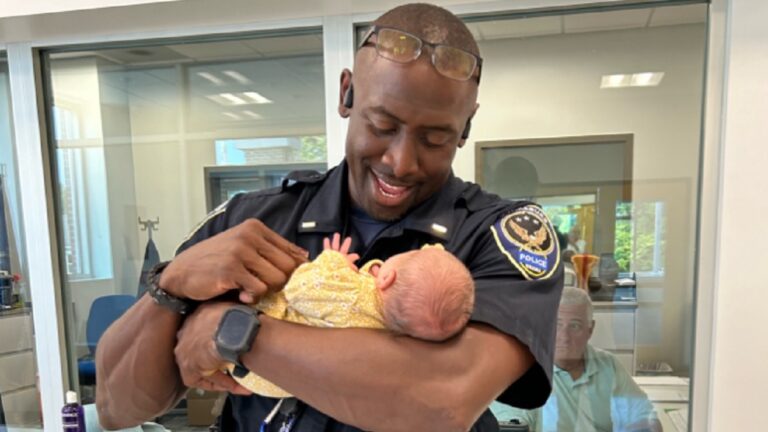 Lieutenant Hayes of Virginia, holding a baby he helped deliver