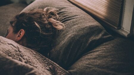 Woman sleeping in bed.
