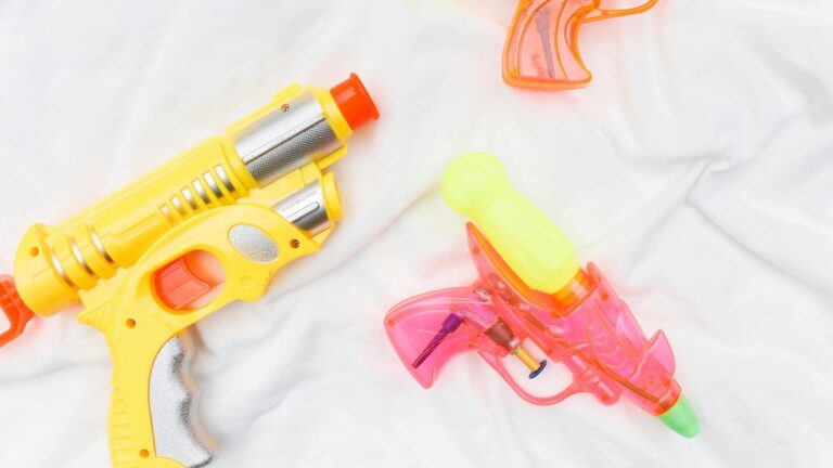 multiple water guns on blanket