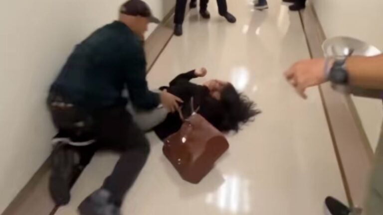 An ICE agent tackles a woman in New York City
